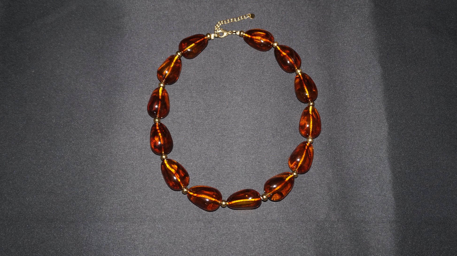 Collier doré en résine ambrée translucide, marbrée et en formes arrondies